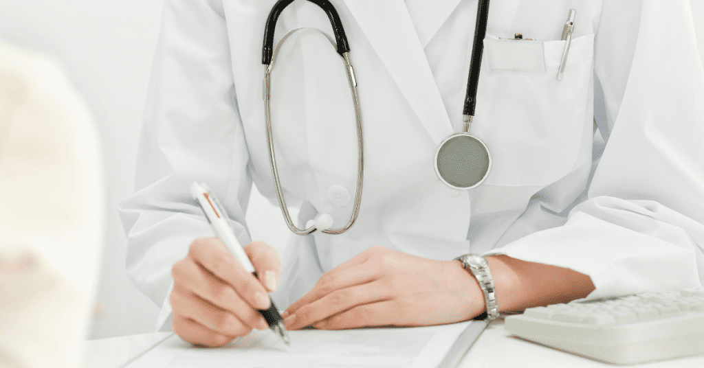 Doctor writing medical codes
